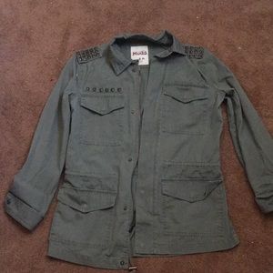 Army green utility jacket with rusty studs.